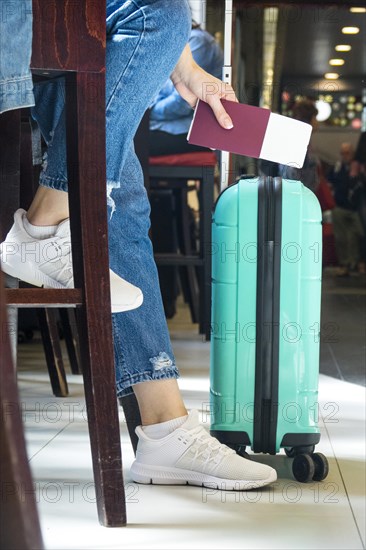 Side view woman sitting airport