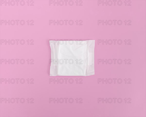 Closed sanitary towel pink background