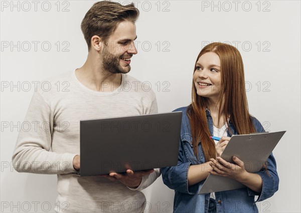 Redhead businesswoman working laptop with her coworker