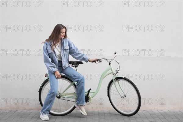 Woman sitting her bike outdoors