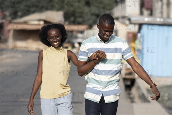 Medium shot african couple holding hands