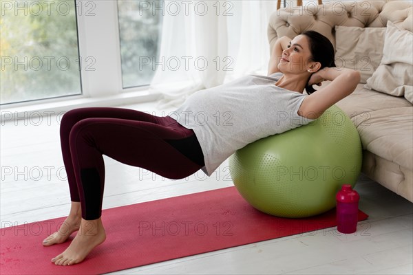 Pregnant woman exercising fitness ball