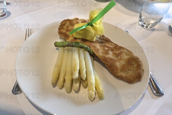 Viennese veal escalope served with asparagus in a restaurant