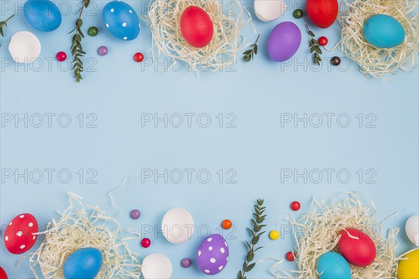 Easter eggs nests with plant branches candies