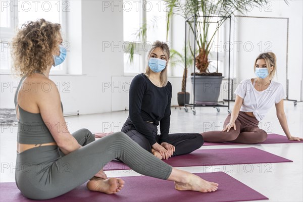 Full shot women wearing masks