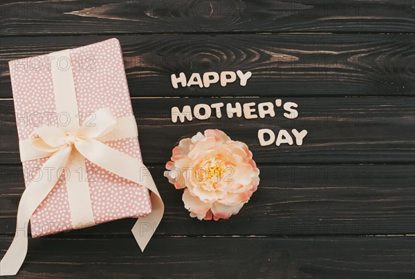 Happy mothers day inscription with gift box flower