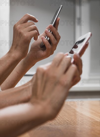 Close up hands typing messages phones