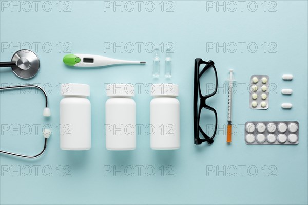 Medicines healthcare accessories arranged blue surface