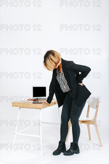 Tired office worker having spine problem