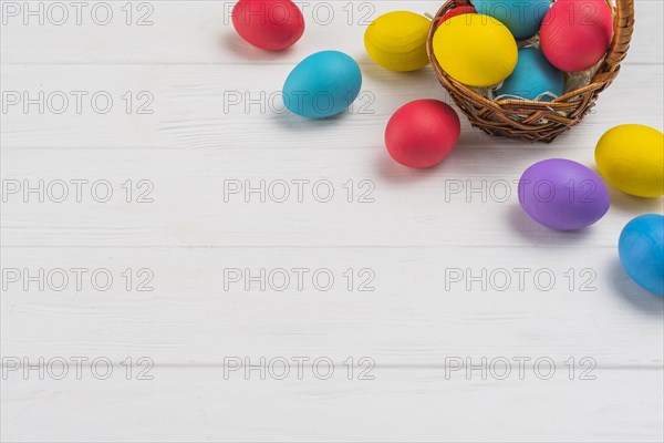 Basket with easter eggs wooden table