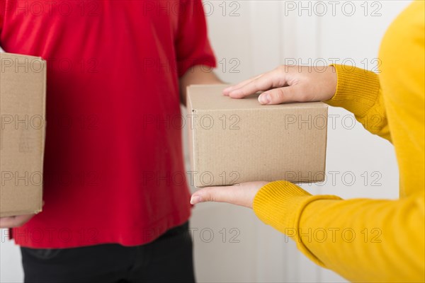 Woman taking package from delivery man