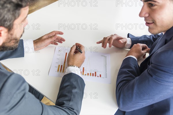 Close up businessmen working company financial report white desk