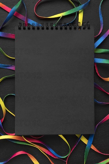 Colorful shoelaces arrangement with black notepad