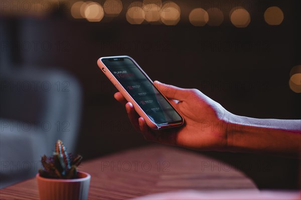 Side view man holding smartphone hand