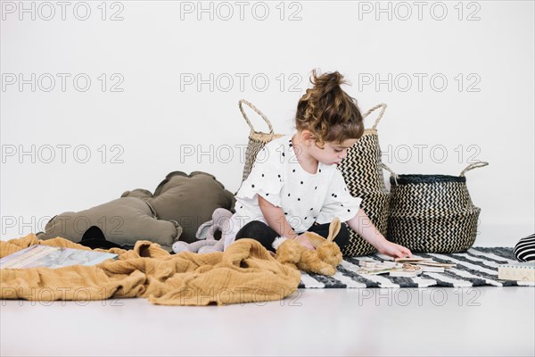 Girl looking toys striped rag