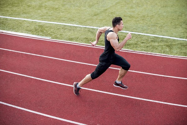 Male athlete arrives finish line racetrack during training session