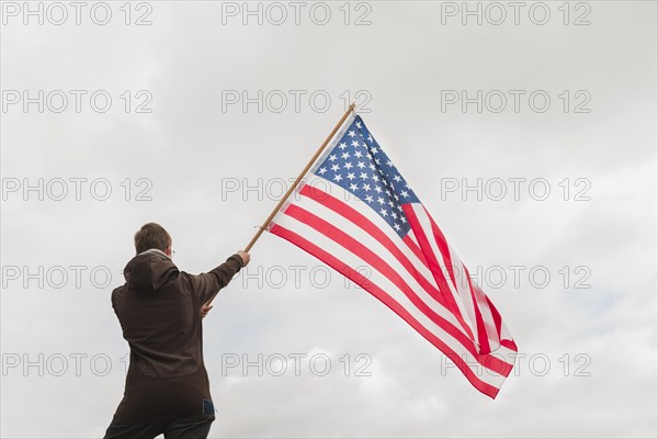 Man waving american flag