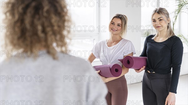 Women holding yoga mat