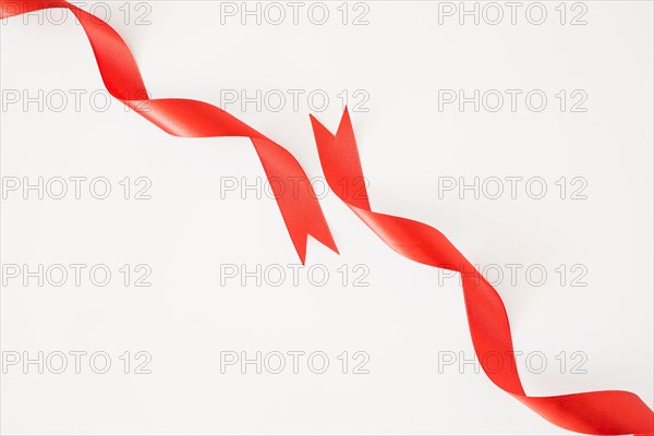 Curled red ribbons white background