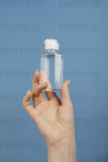 Close up hand with hand sanitizer bottle