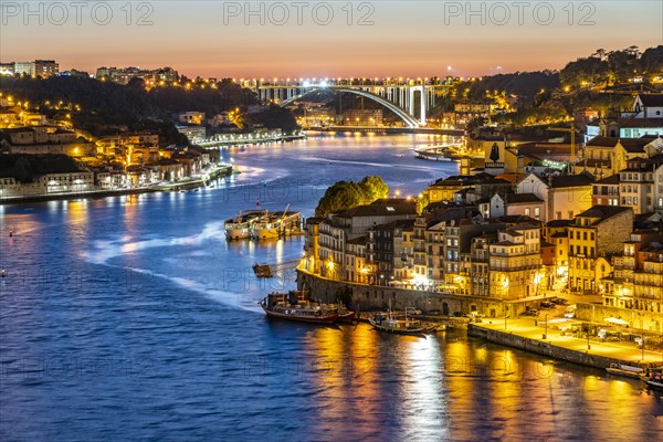 View over the river Douro to the old town of Porto and Vila Nova de Gaia at dusk