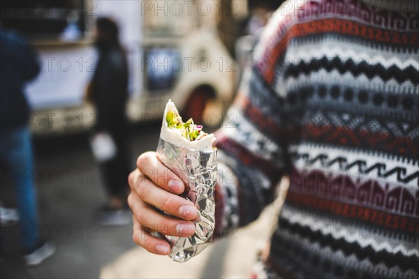 Close up man eating shawarma