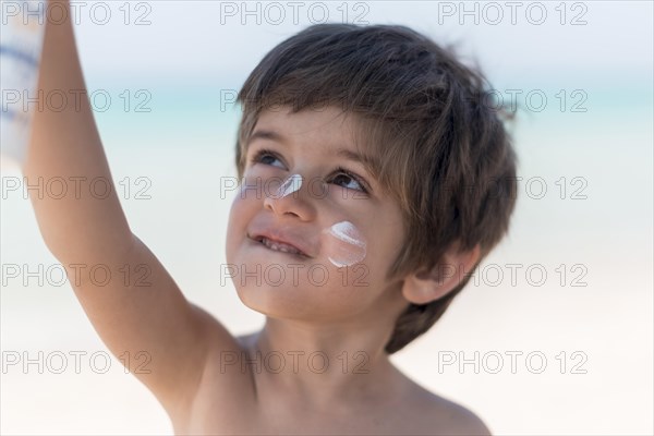 Cute boy beach looking up