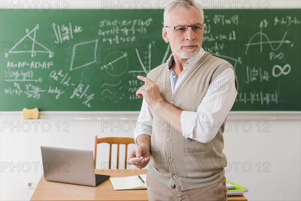 Old professor showing classroom