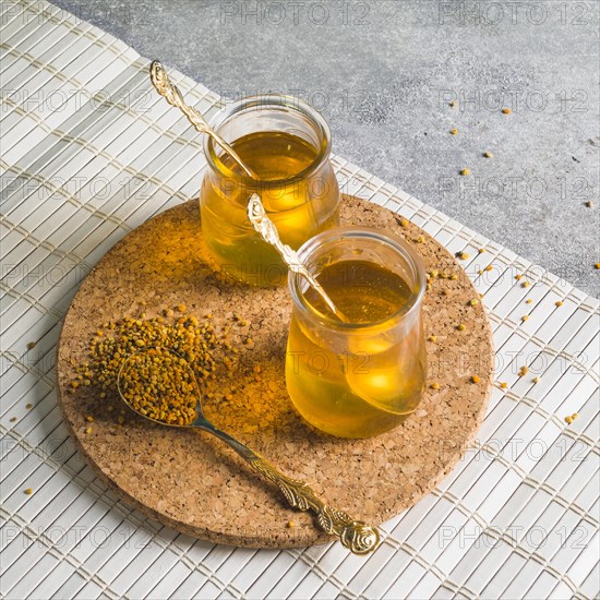 Two honey pots with bee pollens circular cork coaster