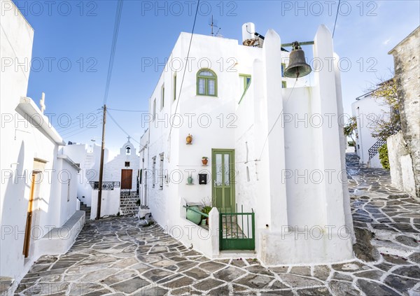 White Cycladic houses with green windows and doors
