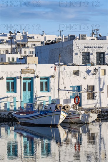 Fishing boats in Naoussa harbour with reflection