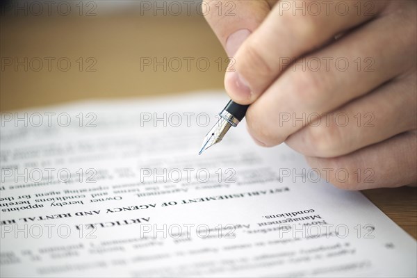 Close up hand signing contract