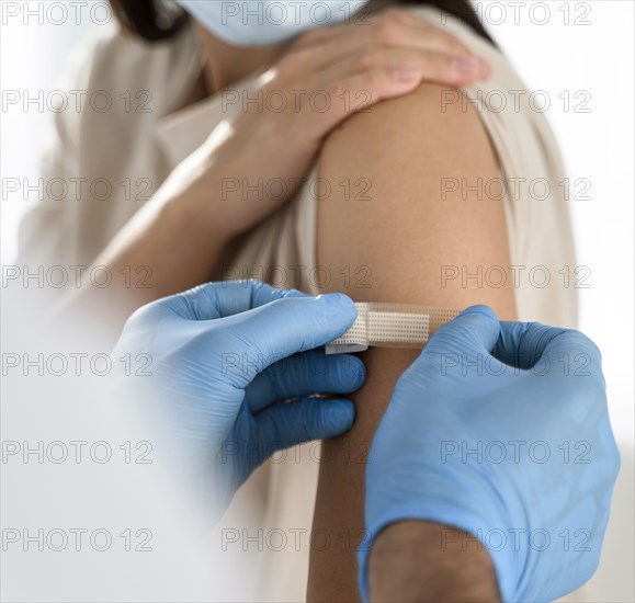 Doctor putting bandage patient s arm close up