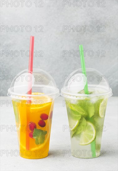 Front view cups with soft drinks straws
