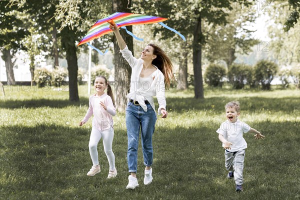 Children mom playing with colourful kite