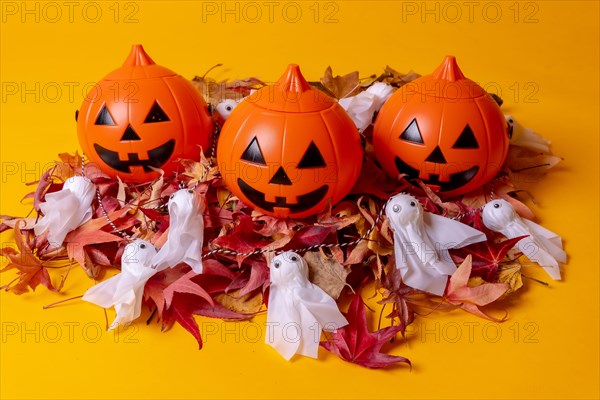 Halloween orange pumpkins on a yellow studio background