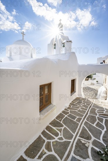 White Greek Orthodox church with sun star