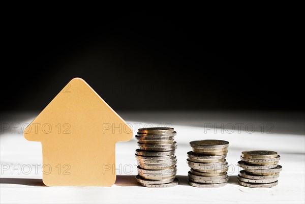 Various piles coins arrow pointing up