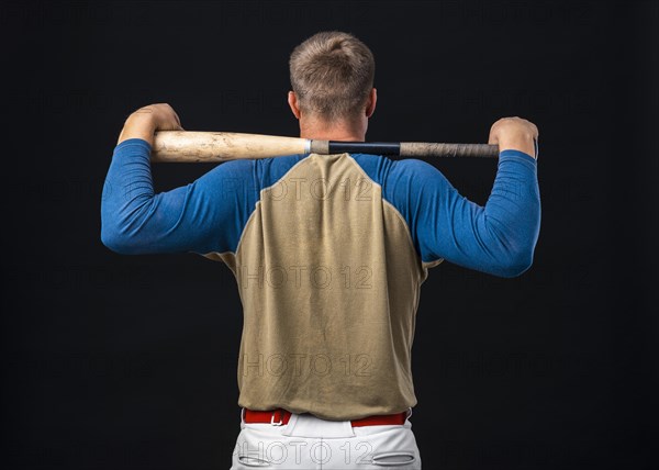 Back view baseball player holding bat