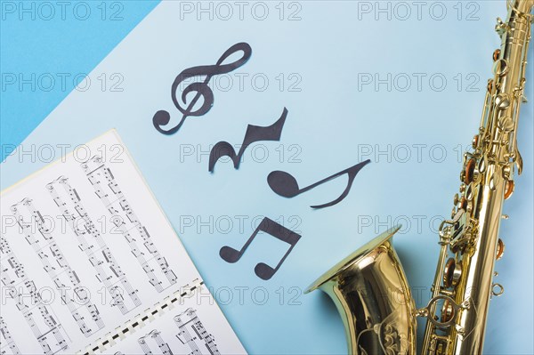 Musical notebook golden saxophones blue backdrop