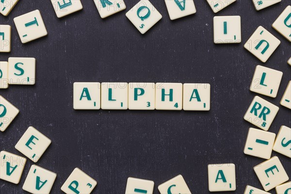 Overhead view alpha text scrabble letters black backdrop