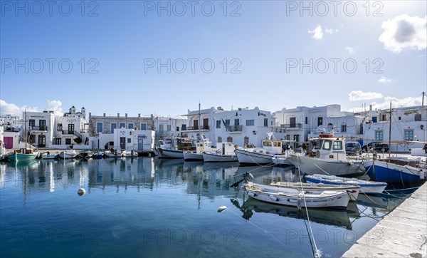 Fishing boats in Naoussa harbour with reflection