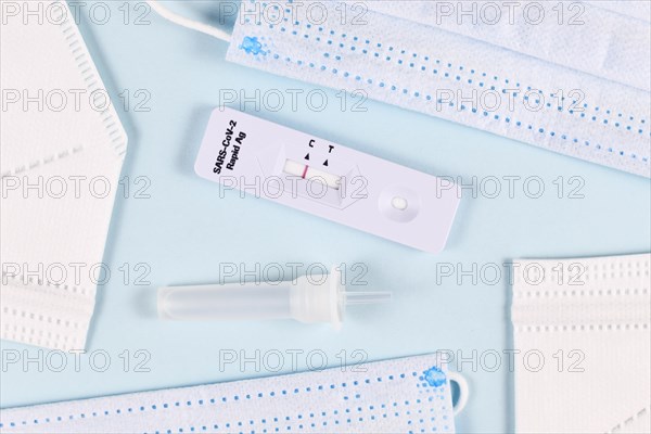 Corona virus rapid antigen test with negative result and medical face masks on blue background