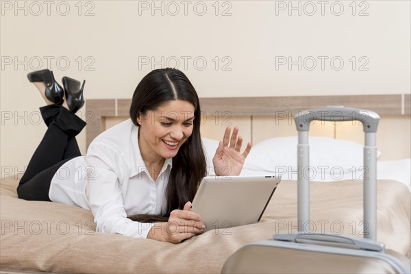 Woman using tablet hotel room