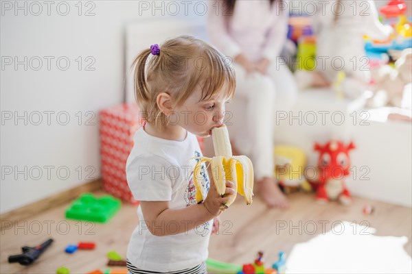 Charming girl enjoying banana