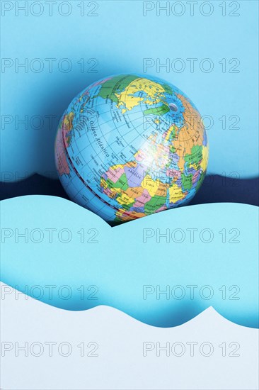 Top view earth globe with paper ocean waves