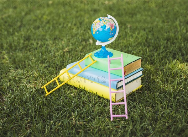 Mini globe top textbook pile