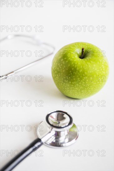 Green apple stethoscope white background