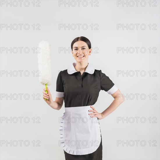 Maid with duster smiling