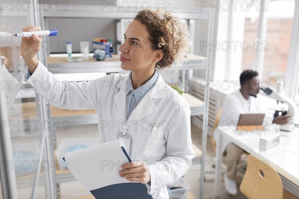 Researcher with clipboard biotechnology laboratory